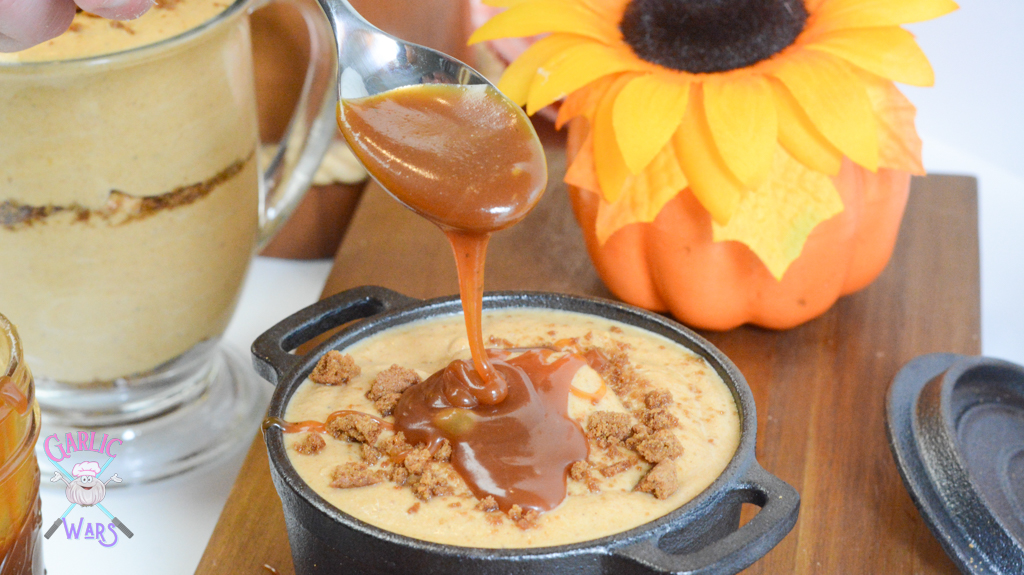 a small skillet of pumpkin mousse being drizzled in caramel