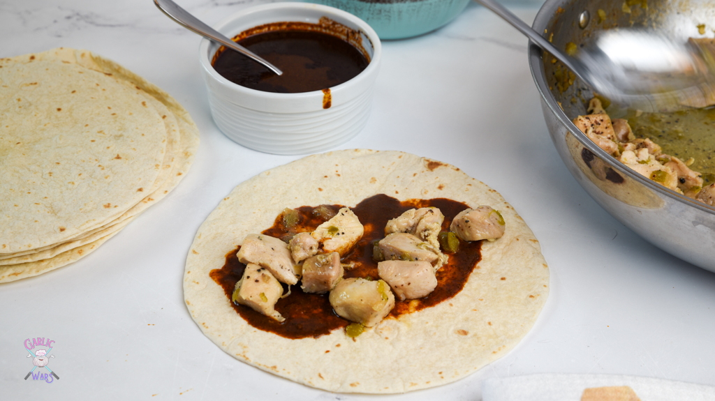 open tortilla with sauce and chicken