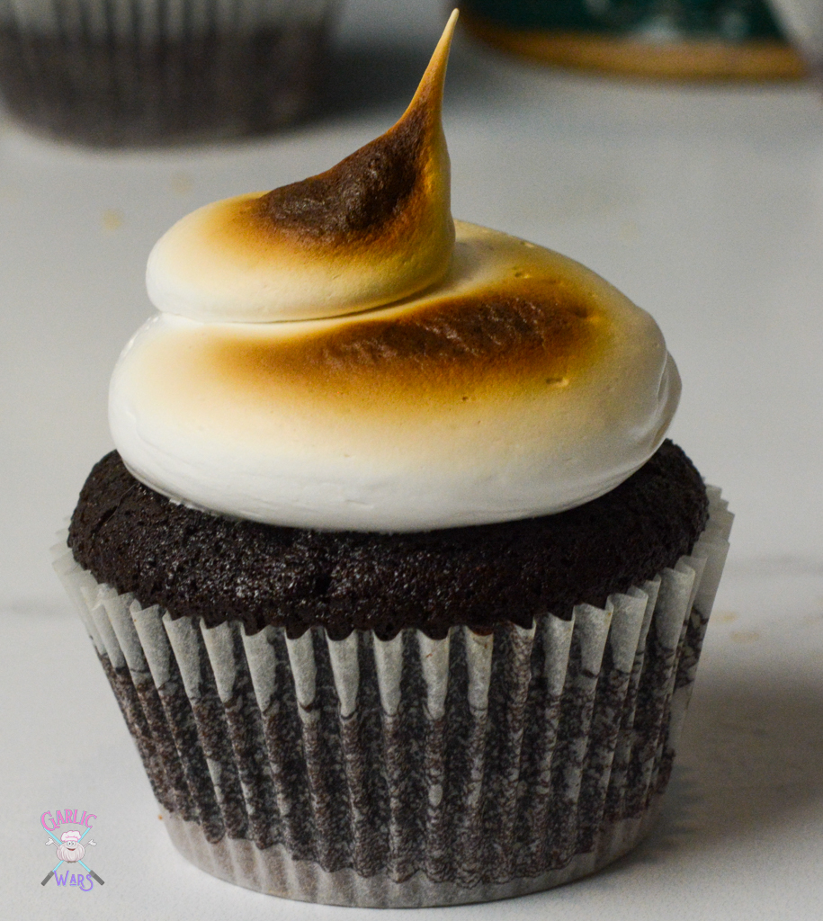 chocolate cupcake with marshmallow frosting, piped on top and then burnt