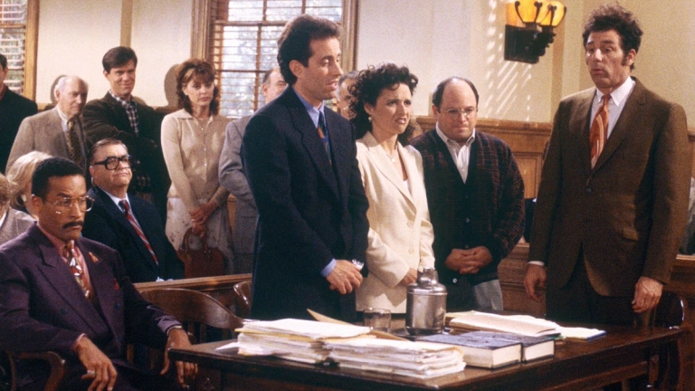 Jackie Chiles, Jerry, Elaine, George, and Kramer in a court room, awaiting their sentencing.