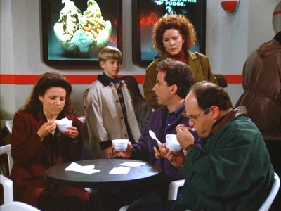 Jerry, Elaine, and George sit in the yogurt shop.