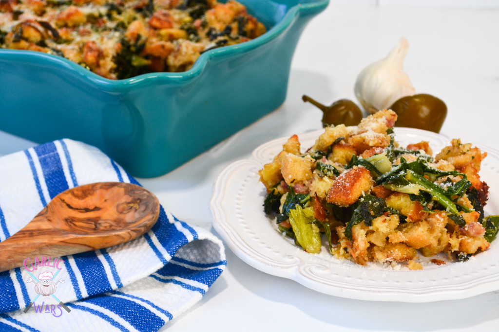 utica greens stuffing on a small white plate beside large casserole dish of stuffing