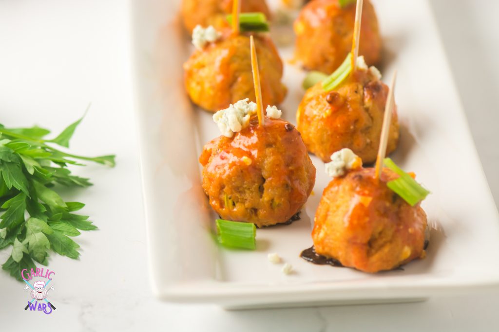 buffalo chicken meatballs on long serving tray with toothpicks