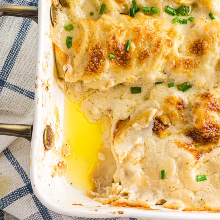 scalloped potatoes in casserole pan with some taken out