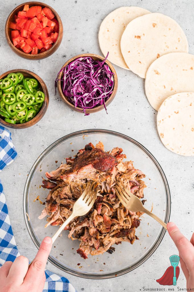 shredding pork with two forks