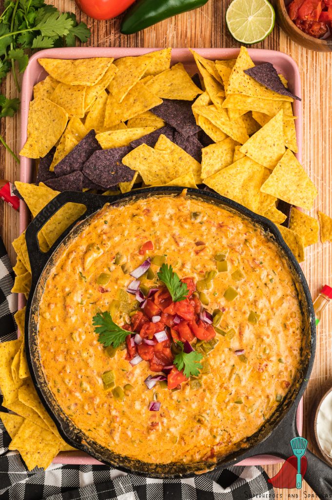 smoked queso in a cast iron skillet served on a baking sheet with tortilla chips
