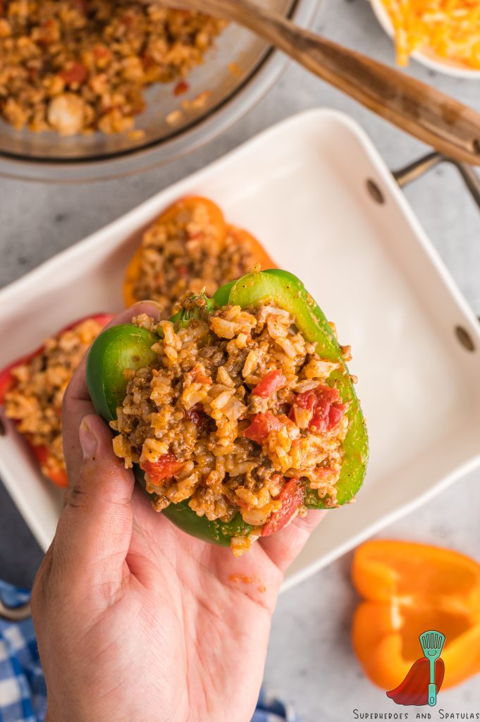 holding up one pepper stuffed with taco meat