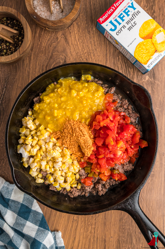 ground beef with corn, taco seasoning, and rotel in cast iron pan