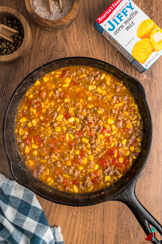 ground beef with corn, taco seasoning, and rotel in cast iron pan